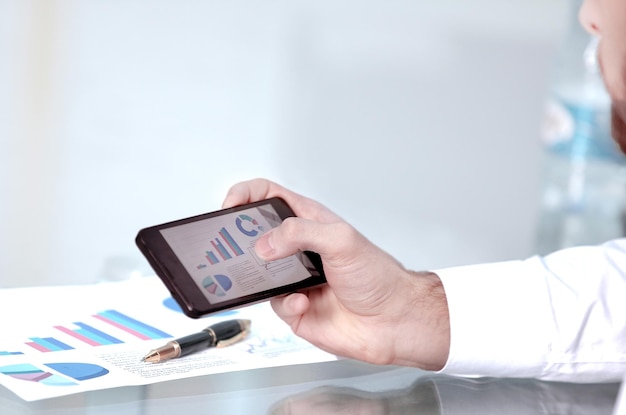 Close up of a man using mobile smart phone