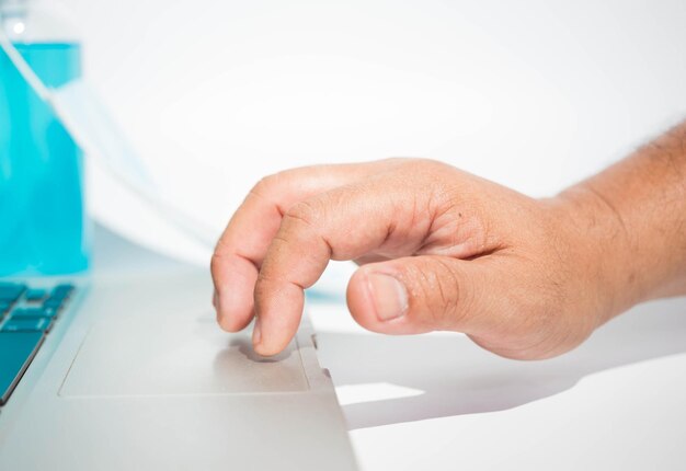 Close-up of man using smart phone on table