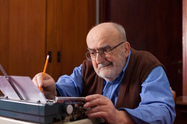 Photo close-up of man using typewriter