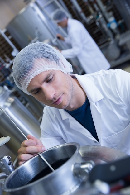 Close up of a man wearing a hair net in the factory