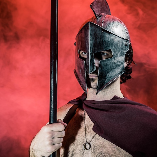 Close-up of man wearing helmet against wall