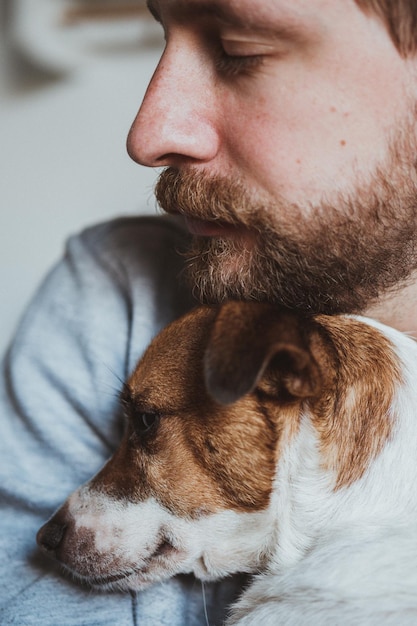 Close-up of man with dog at home