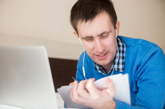 Close-up of man with earphones working