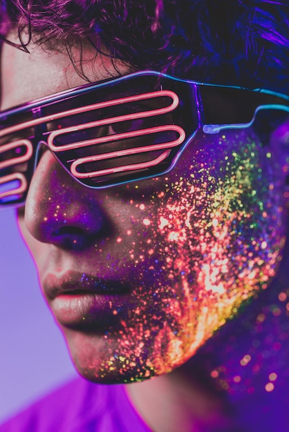 close-up of man with multi colored face paint wearing eyewear