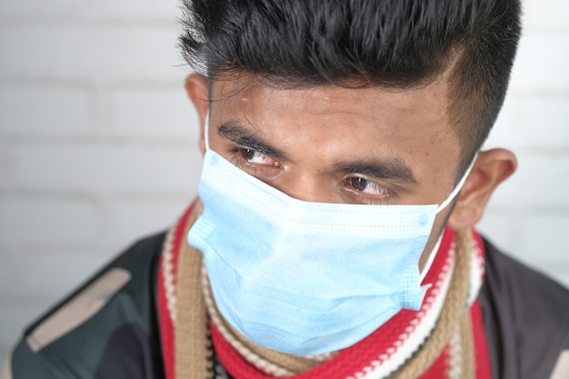 Close up of man with protective face mask looking at camera