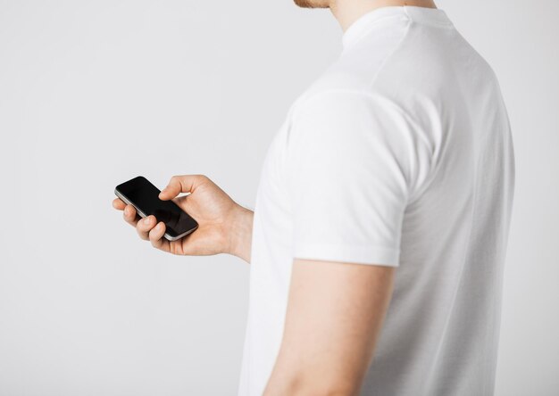 close up of man with smartphone typing something