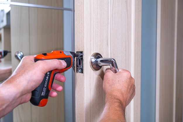 Close-up of man working on metal door