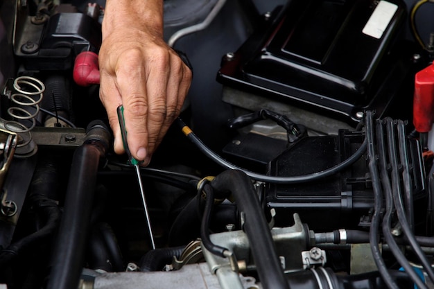 Close-up of man working on motorcycle