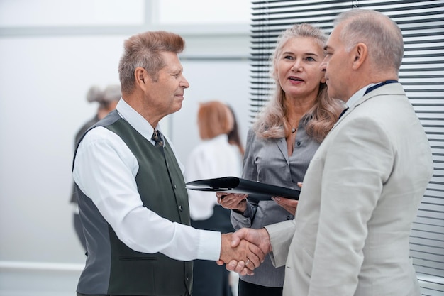 Close up manager and customer shaking hands