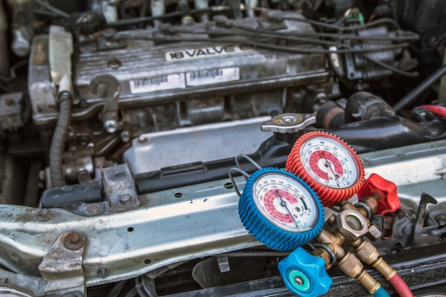 Close up manifold gauge on car engine.