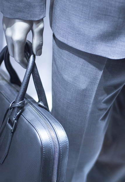 Photo close-up of mannequin with bag at store