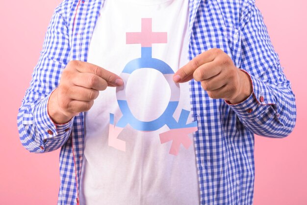 Photo close up of mans hands with a third gender symbol on an isolated background diversity concept