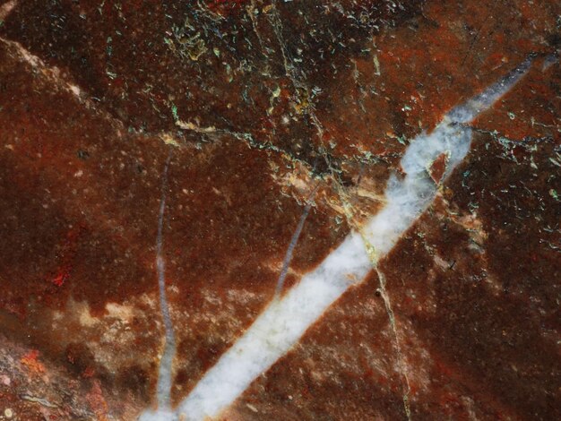 A close up of a marble with a white line in the center.