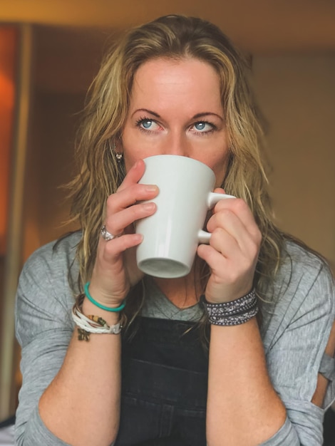 close-up of mature woman drinking coffee at home