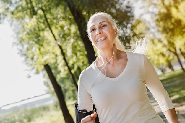 Close up of mature woman running in park