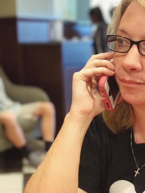 Photo close-up of mature woman talking on mobile phone