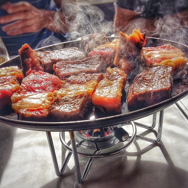 Photo close-up of meat preparing on stove