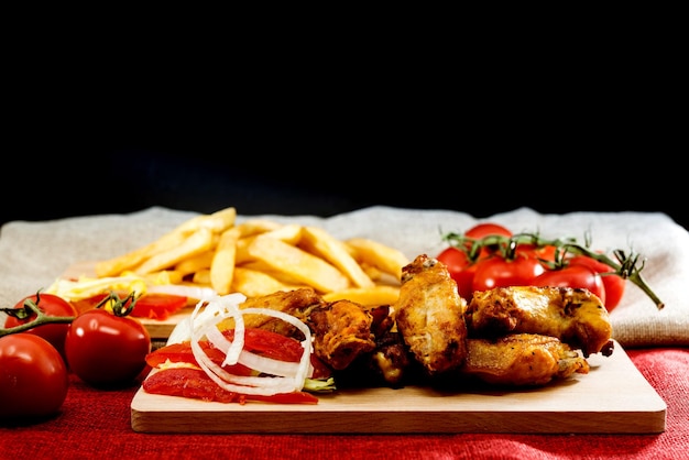 Close-up of meat and vegetables on cutting board against black background