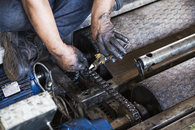 Close-up of mechanic repairing machinery