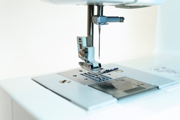 Close-up: the mechanism of the sewing machine. White background.