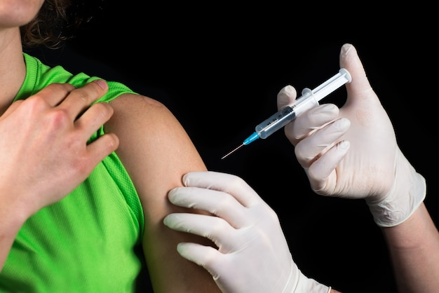 Close-up of a medical man doing an injection