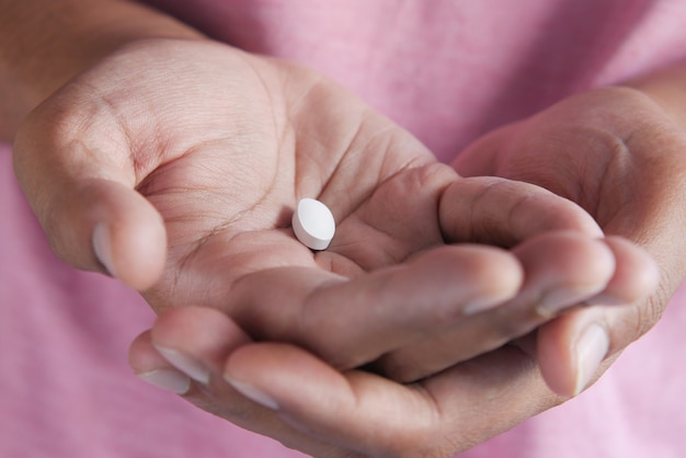 Close up of medical pill on palm of hand