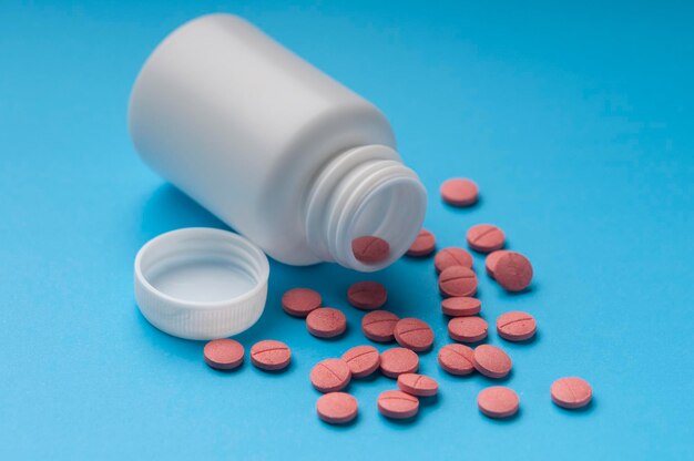 Close-up of medicines and bottle on blue background