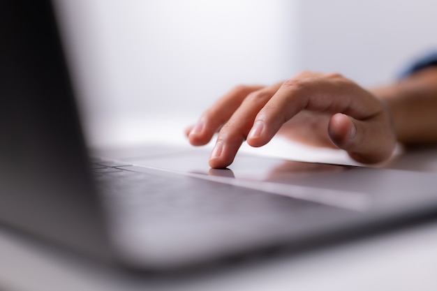 Close up of men hand using modern laptop