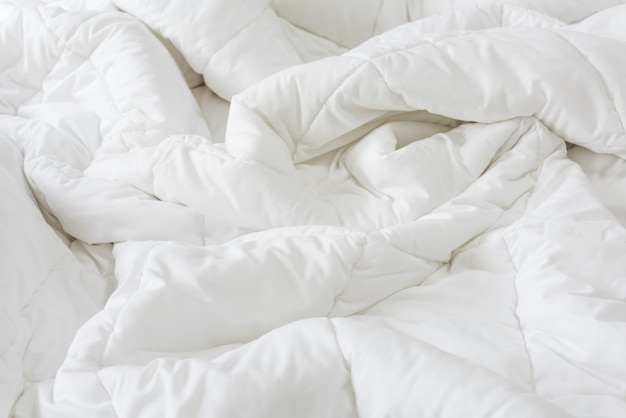 Photo close up messy white sheet and pillows on bed bedroom interior