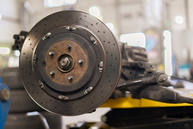 A close up metal chrome brake disk, repair vehicle parts of the sport car