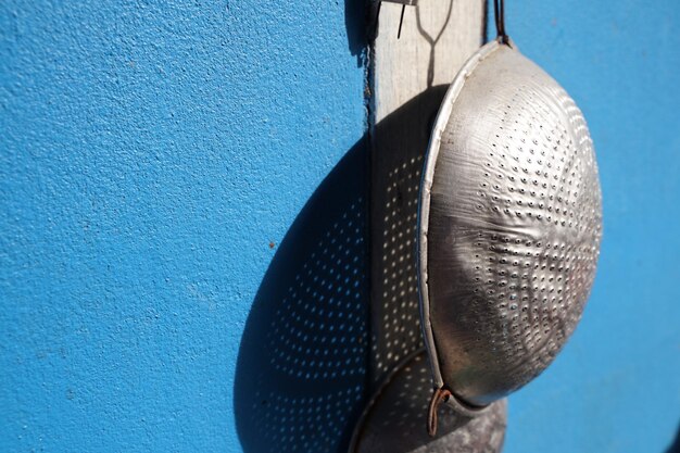 Close-up of metal hanging against wall