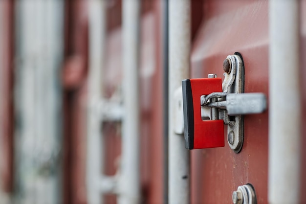Close up of metal lock on door of cargo container in shipping\
docks copy space