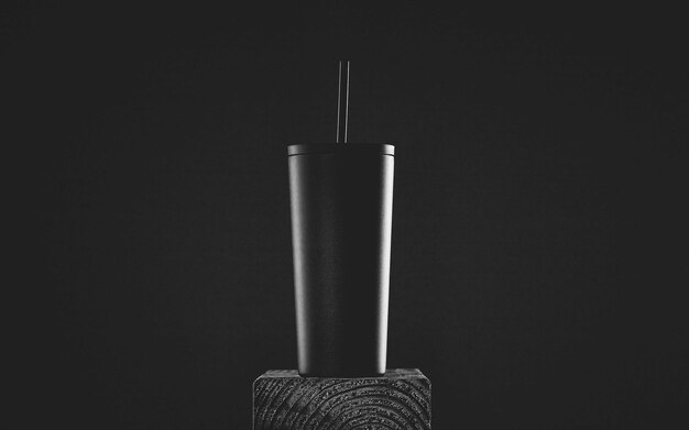 Close-up of metal mug against a black background