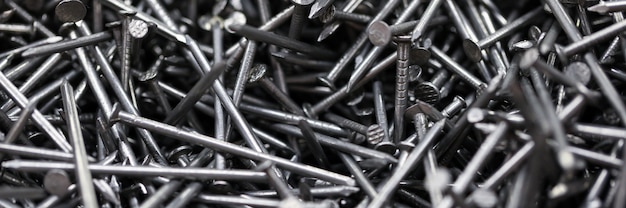 Close-up of metal tacks. Lots of nails to repair furniture. Detailed picture with bunch of worker tool. Used for fixing wooden materials. Construction concept