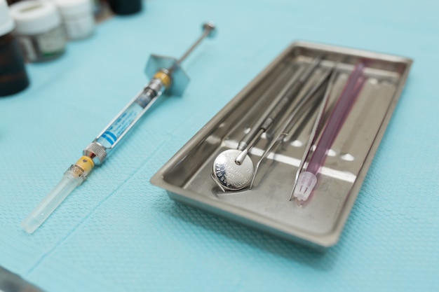 Close up metal tray with dental tools.