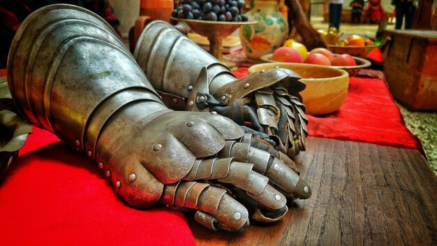 Close-up of metallic gloves on table