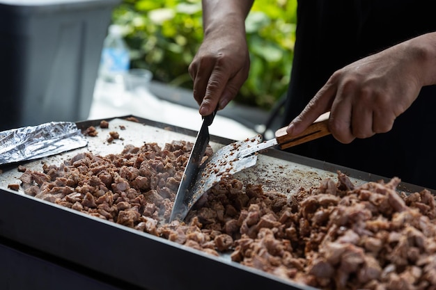 Close up of Mexican taquero cutting the pastor meat in the center of Mexico City