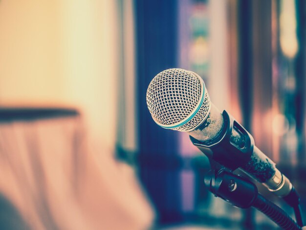 Close up of microphone on abstract blurred background for speech in seminar room or communication and speaking conference hall Background concept