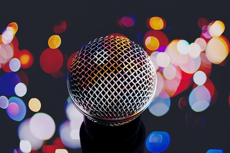 Photo close-up of microphone against illuminated lighting