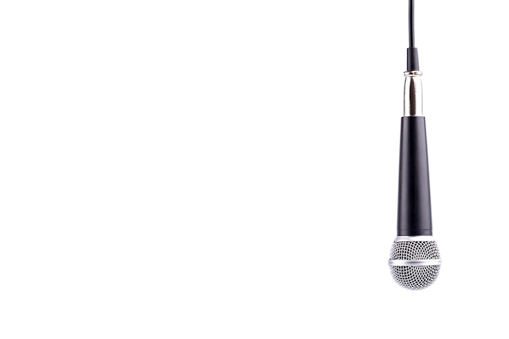 Photo close-up of microphone against white background