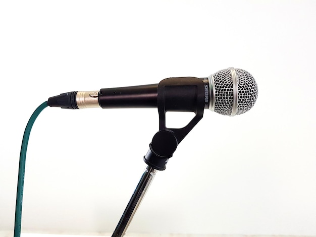 Photo close-up of microphone against white background