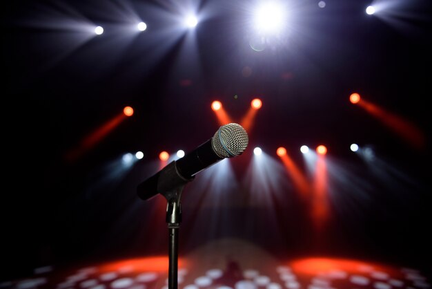 Close-up of microphone at concert against blur colorful light