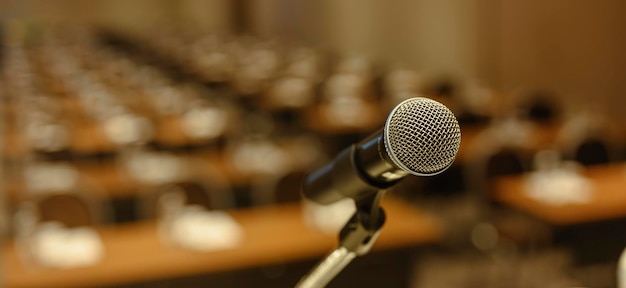 Close up of microphone on stage in meeting room. Blurred background. Microphone, stage, room, class, meeting, greeting concept.