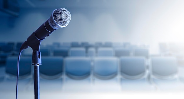 Photo close up of microphone on stand in conference room