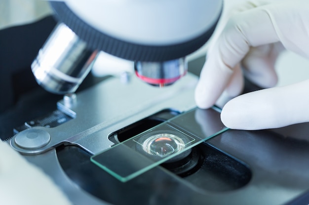 Photo close up of microscope at the blood laboratory, concept science and technology