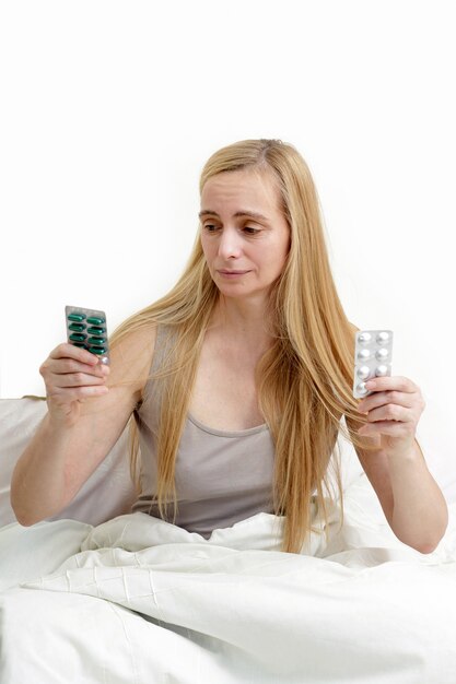 Close up on middle age blonde woman in bed