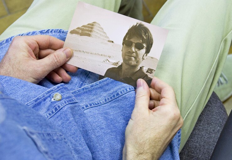 Photo close-up midsection of man holding photograph