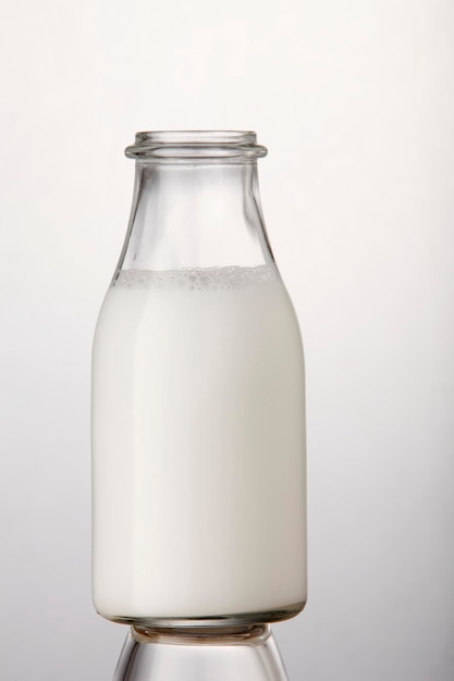 Photo close-up of milk bottle against white background