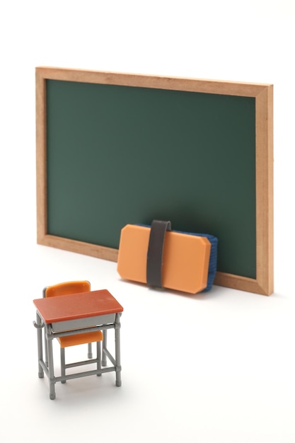 Photo close-up of miniature classroom equipment over white background
