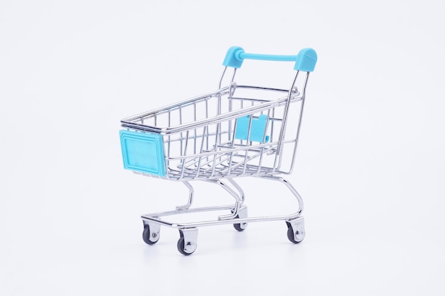 close-up of miniature shopping cart against white background